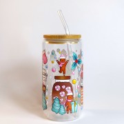 Szklany kubek 550 ml z bambusową pokrywką i słomką - pierniczki w różowych czapeczkach i szaliczkach wokół pastelowych kubków na wynos - pocichutku.pl
